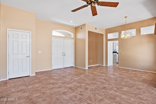 interior space with baseboards, visible vents, and ceiling fan with notable chandelier