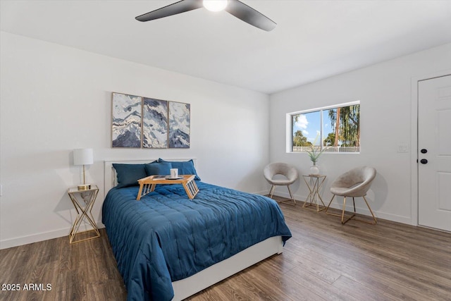 bedroom featuring a ceiling fan, baseboards, and wood finished floors