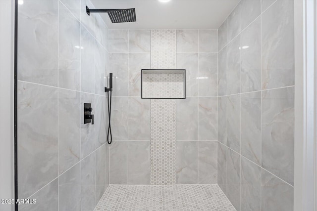 full bath featuring a tile shower