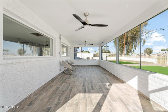 exterior space featuring ceiling fan and fence