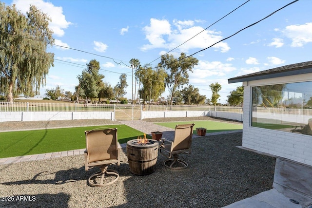 view of yard with fence and a fire pit