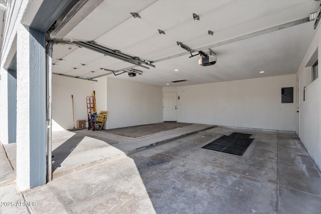 garage with electric panel and a garage door opener