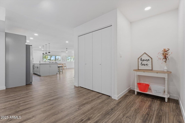 interior space featuring recessed lighting, wood finished floors, and baseboards