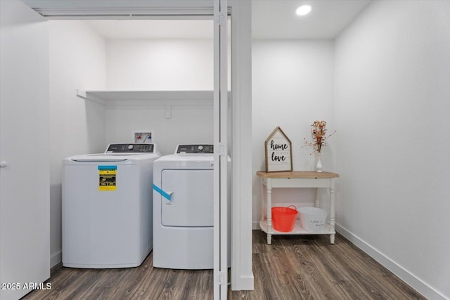 laundry area featuring washer and dryer, baseboards, dark wood-type flooring, and laundry area