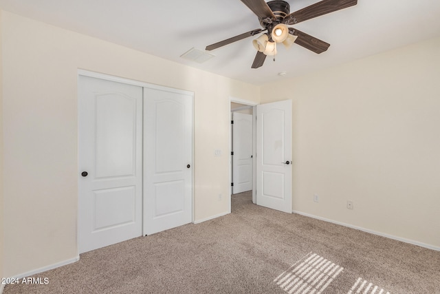 unfurnished bedroom featuring a closet, ceiling fan, and carpet flooring