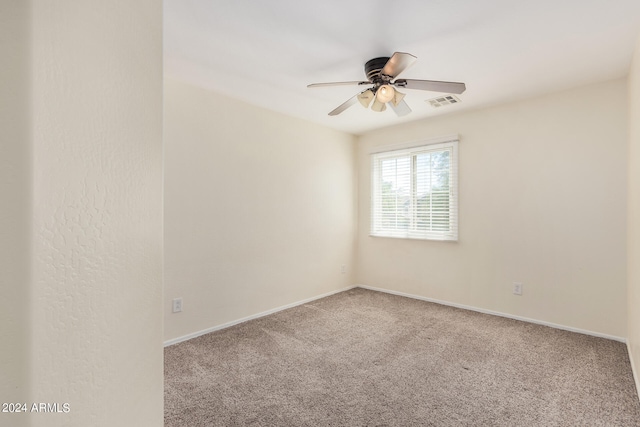 empty room with ceiling fan and carpet flooring