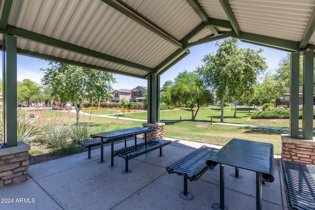 view of property's community with a patio and a lawn