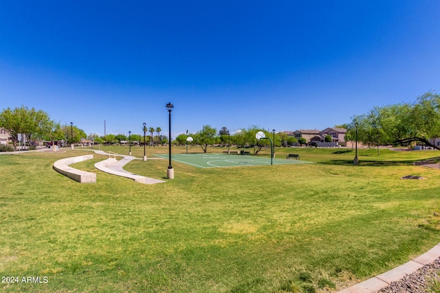 view of community with a lawn and basketball court