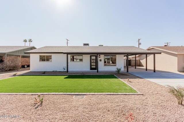 ranch-style house featuring a front yard and a carport