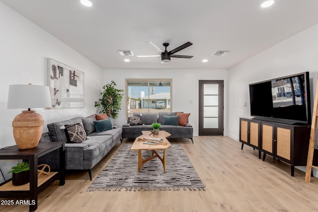 living room featuring light hardwood / wood-style flooring and ceiling fan