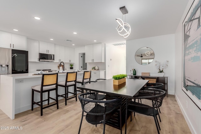 dining space with light hardwood / wood-style flooring