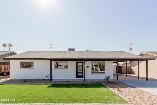 ranch-style house featuring a carport and a front lawn