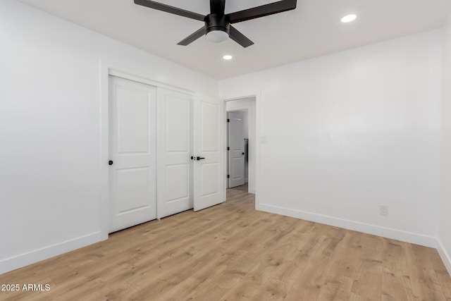 unfurnished bedroom with ceiling fan, light hardwood / wood-style floors, and a closet