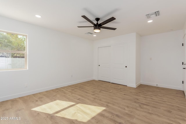 unfurnished room with ceiling fan and light hardwood / wood-style floors