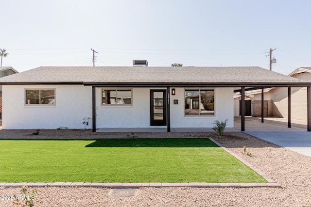 ranch-style home featuring a carport and a front lawn