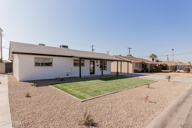 single story home featuring a front lawn