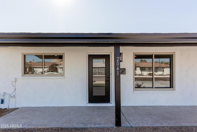 entrance to property featuring a patio