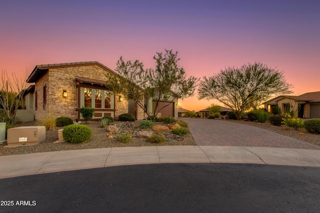 3675 Gold Ridge Rd, Wickenburg, AZ 85390 - view of front of home with stone siding, decorative driveway, and an attached garage
