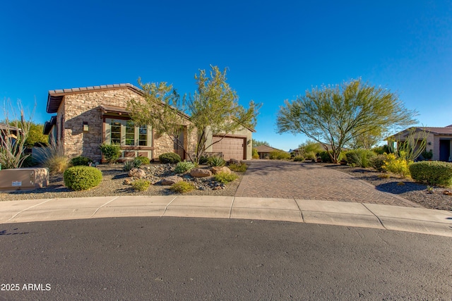 3675 Gold Ridge Rd, Wickenburg, AZ 85390 - view of front of house with stone siding, decorative driveway, and an attached garage