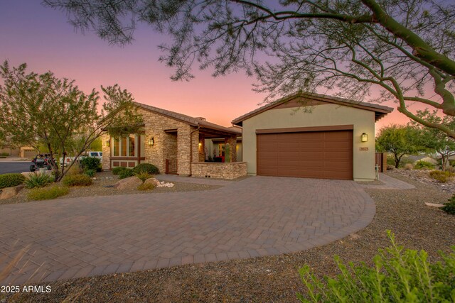 3675 Gold Ridge Rd, Wickenburg, AZ 85390 - view of front facade featuring driveway, an attached garage, stone siding, and stucco siding