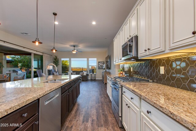 3675 Gold Ridge Rd, Wickenburg, AZ 85390 - kitchen featuring stainless steel appliances, a sink, dark wood finished floors, white cabinetry, and backsplash