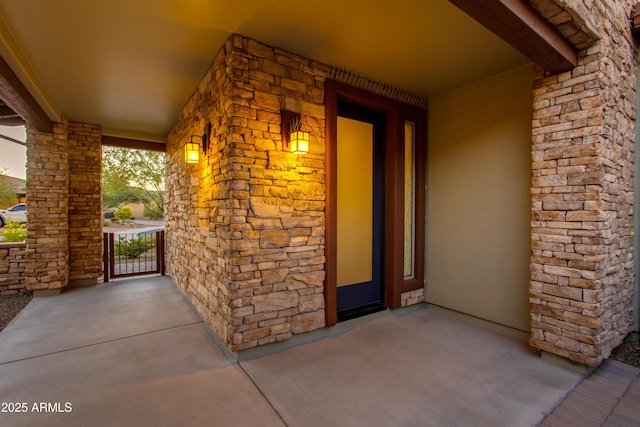 3675 Gold Ridge Rd, Wickenburg, AZ 85390 - property entrance featuring covered porch, stone siding, and stucco siding