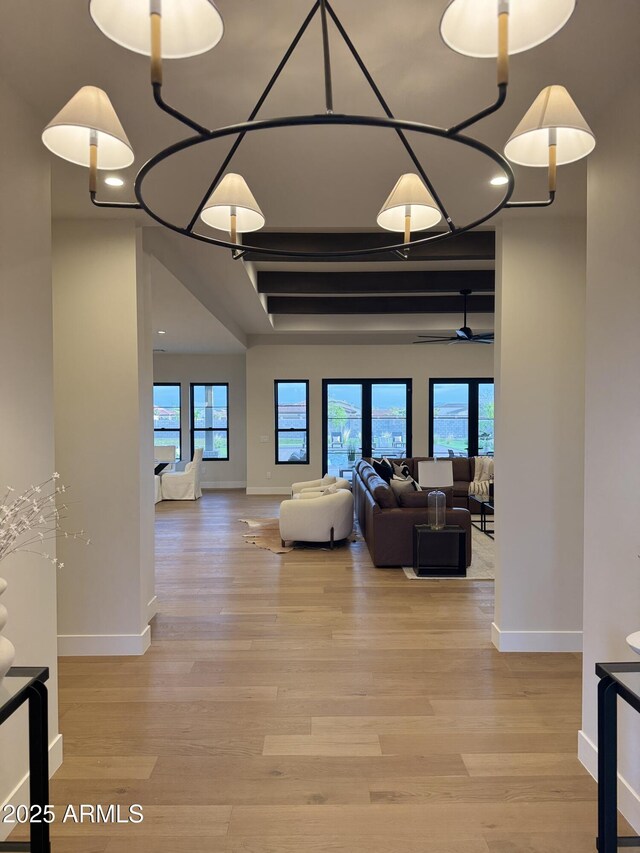 living room with baseboards and light wood-style flooring