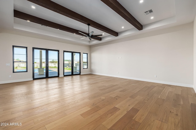 spare room featuring french doors, ceiling fan, beam ceiling, and light hardwood / wood-style flooring