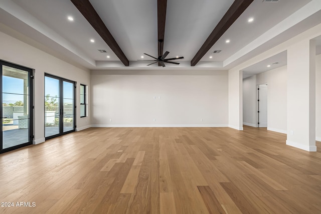 unfurnished living room featuring light hardwood / wood-style flooring, french doors, beam ceiling, and ceiling fan