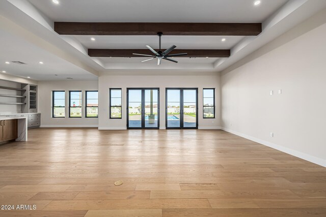 unfurnished living room with french doors, light hardwood / wood-style floors, beam ceiling, and ceiling fan