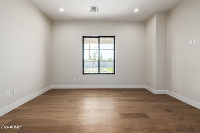 empty room with dark hardwood / wood-style flooring