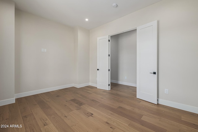 unfurnished bedroom featuring a closet and light wood-type flooring