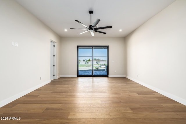 unfurnished room with light hardwood / wood-style flooring and ceiling fan