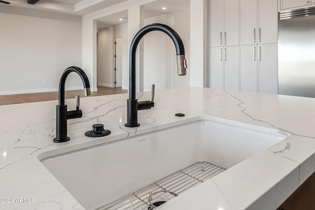 room details with recessed lighting, a sink, and built in refrigerator