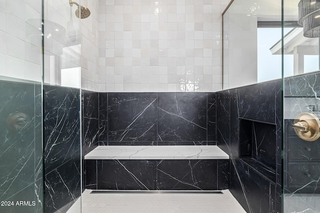 bathroom featuring tile walls and tiled shower