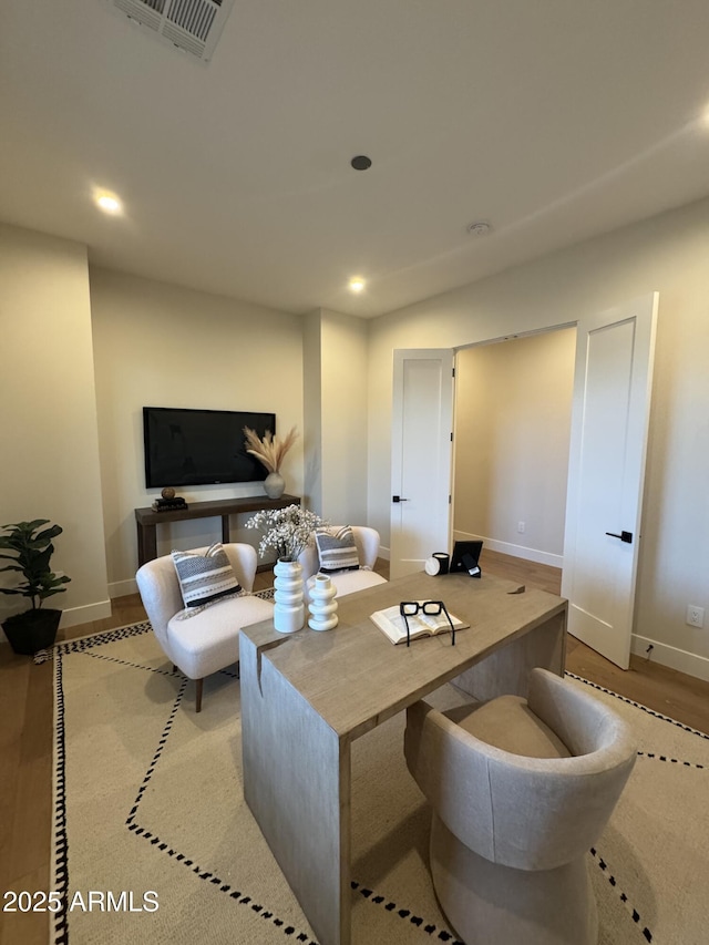 living area featuring recessed lighting, baseboards, and visible vents