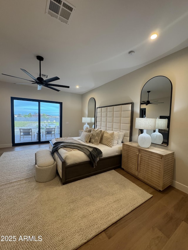 bedroom featuring visible vents, wood finished floors, baseboards, ceiling fan, and access to outside