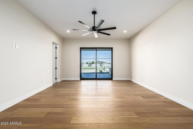 empty room with recessed lighting, baseboards, a ceiling fan, and light wood-type flooring