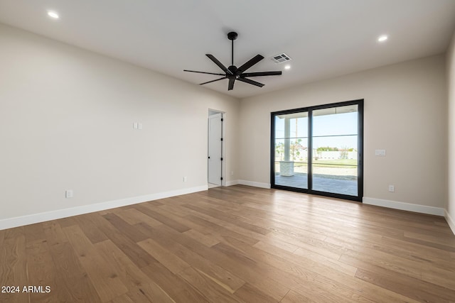 spare room featuring visible vents, wood finished floors, baseboards, ceiling fan, and recessed lighting