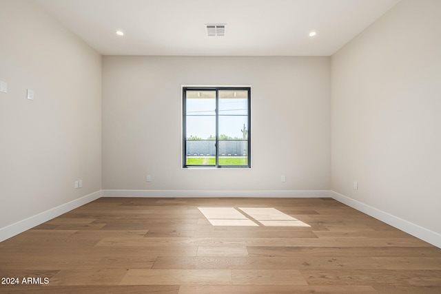 empty room with light hardwood / wood-style flooring