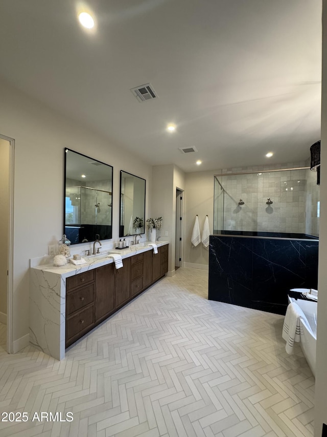 full bath with walk in shower, visible vents, and a sink