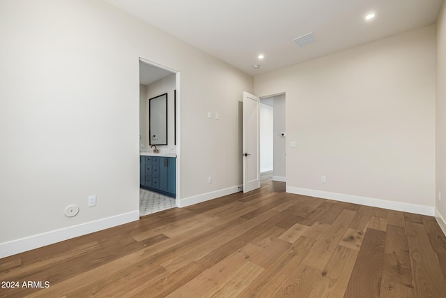 unfurnished room with recessed lighting, baseboards, and light wood-style flooring