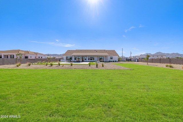 rear view of house with a lawn