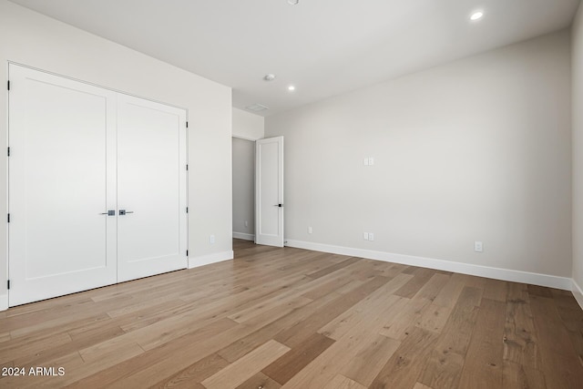 unfurnished bedroom with light wood-style floors, baseboards, and recessed lighting