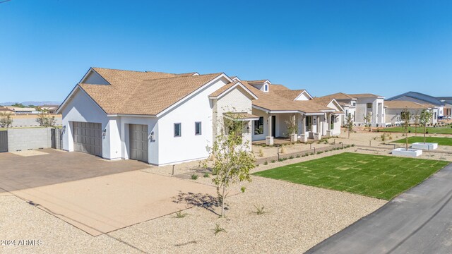 view of front of home with a front yard and a garage