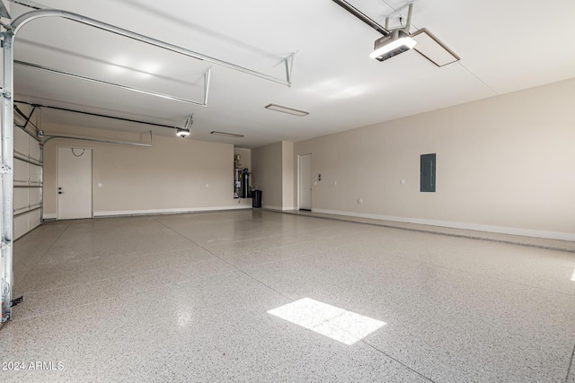 garage featuring baseboards, a garage door opener, and electric panel
