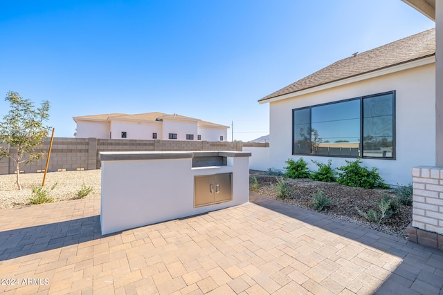 view of patio with a fenced backyard and area for grilling