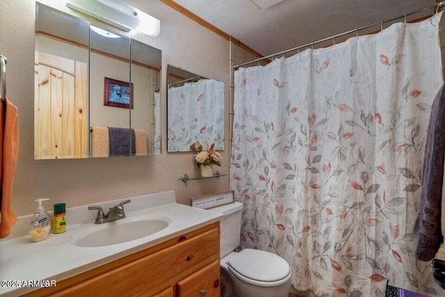 bathroom with toilet, vanity, and a shower with curtain