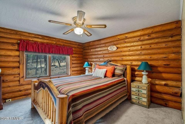 bedroom with a ceiling fan, carpet flooring, and a textured ceiling