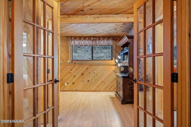 interior space with wood ceiling, wooden walls, french doors, and wood-type flooring